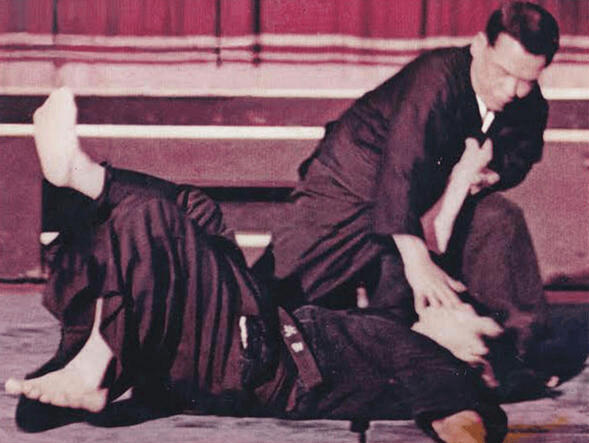 Yasumoto throwing his opponent to the ground